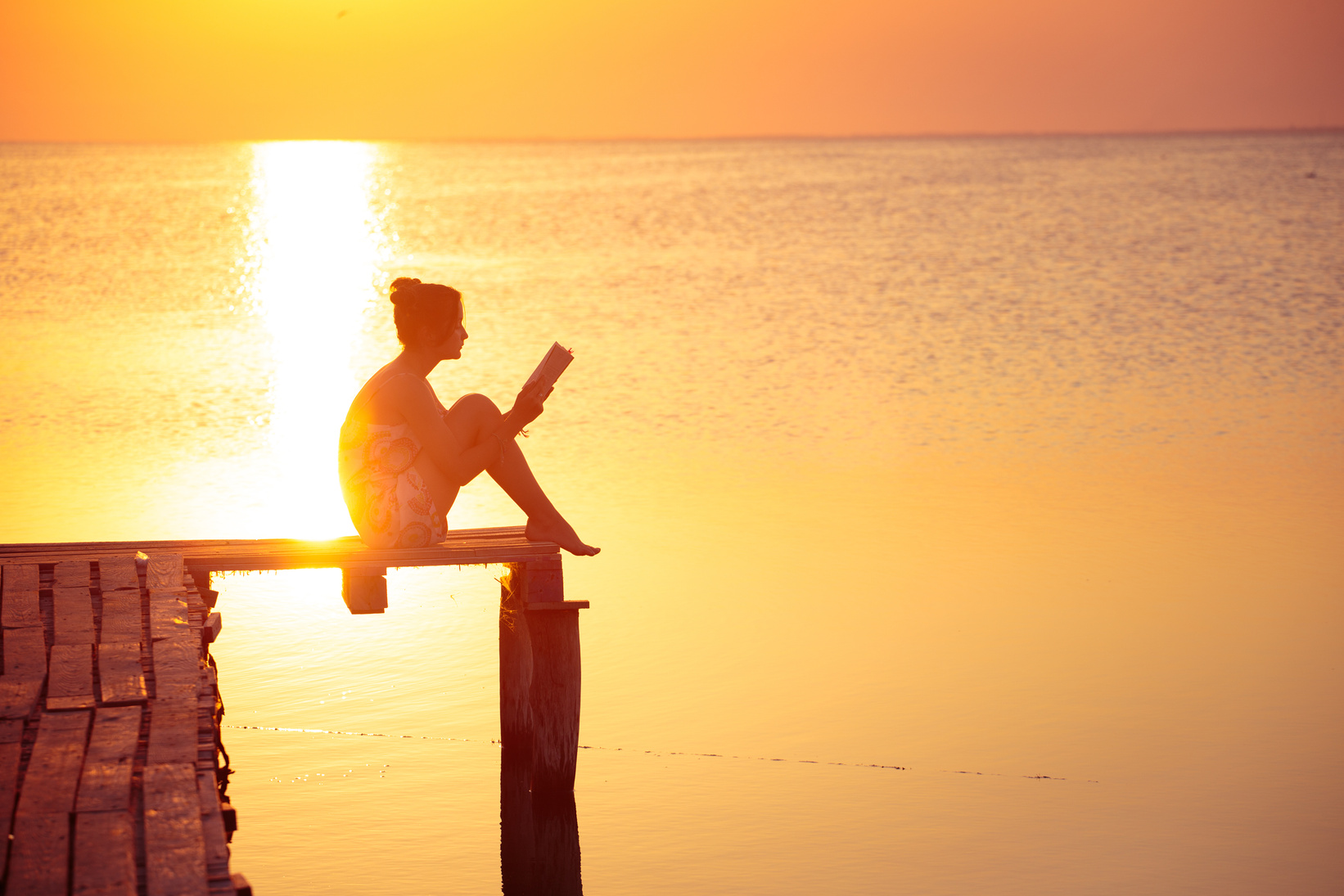 Girl Reading at the Sunset Time